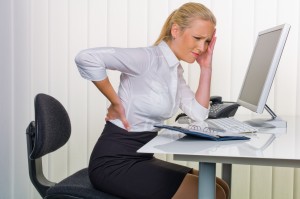 women in the office with back pain